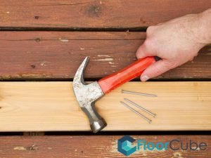 featured-image-hammer-and-nails-on-timber-deck-tips-you-should-consider-for-diy-timber-decking-repair-timber-decking-floorcube-singapore